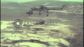 A US Army 160th Combat Aviation Group CH-54 transports a 155mm howitzer in Vietna...HD Stock Footage