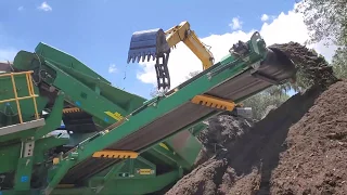 McCloskey R155 with Low Profile Hopper screening soil with large rock