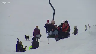 People enjoy first snow of the season at Snoqualmie Pass