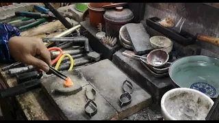 The process of melting down a gold necklace to make a square ring.