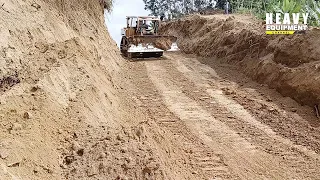 Very Strong Caterpillar D6R XL bulldozer doing mountain-splitting work for plantation roads