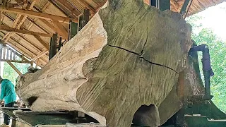 sawing ancient teak logs full of beauty into expensive planks