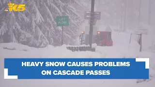 Drivers navigate travel over Cascade passes as snow continues to fall