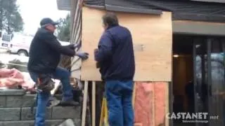 Garbage truck hits house