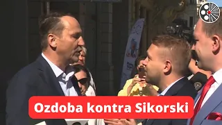 J. Ozdoba zakłóca konferencję R. Sikorskiego