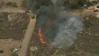 Fire crews battle vegetation fire burning east of Ramona in Witch Creek