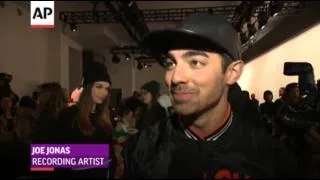 Rowland Licks Chocolate Wall at Fashion Show