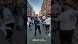 Traditional English folk Morris dancers performing in Soho , central London .