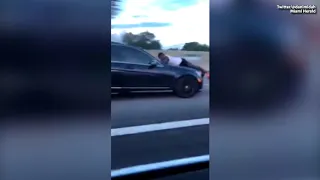 WATCH:  Man Caught Riding on Hood of Car on Major Highway