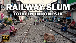 Walking a RAILWAY SLUM TOUR in INDONESIA [4K]