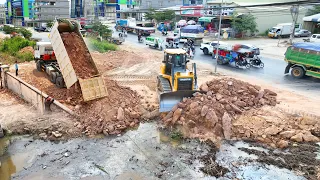 The New Project Bulldozer SHANTUI Clearing Land And Push Stone In Water With DumpTruck Unloadind Sto