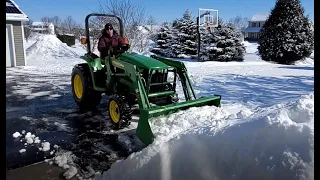 John Deere 3038e clearing snow