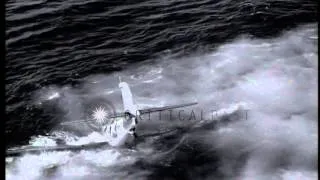 US Navy F6F Hellcat fighter crashes in water alongside USS Monterey (CVL-26) unde...HD Stock Footage