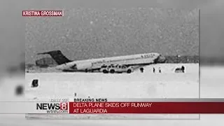 Plane skids off runway at LaGuardia, crashes through fence