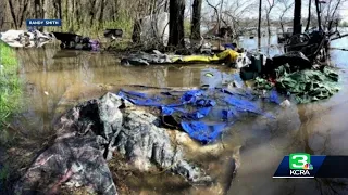 Trash left behind after high water floods homeless camps on American River