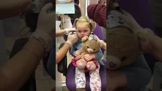 3 year old getting ears pierced at Claire's accessories