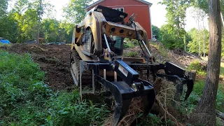 Using the root grapple and rock bucket on a job