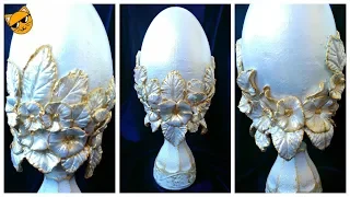 Gypsum egg decorated with paper clay flowers.