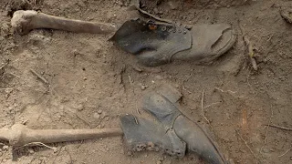 Mass grave of WWII German soldiers unearthed alongside their meagre belongings