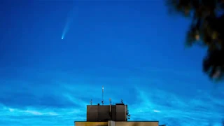 A Comet C/2020 F3 (NEOWISE) Surrounded By Noctilucent Clouds