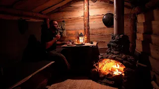 Fireplace in a wooden hut, building a house in nature. Solo overnight in a cabin