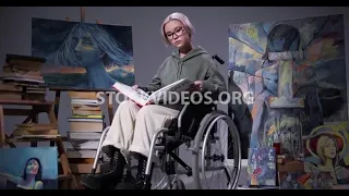 Asian woman student in wheelchair readin...