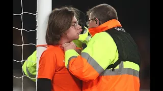 A fan at Everton putting a cable tie around his throat and post.