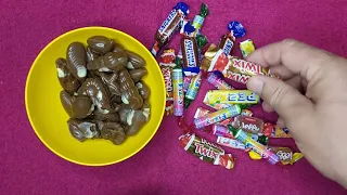 Mellon chocolate candies with filling, candy twix, candy snickers, lollipops PEZ,  FIZZY, ASMR