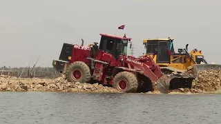 Wow !! Great equipment Machines in operating pushing & unloading Rock in to water