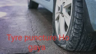 How to change punctured car tyre on road.