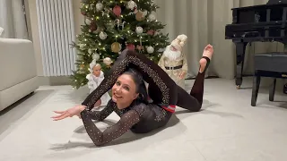 Beautiful flexible girl under the Christmas tree