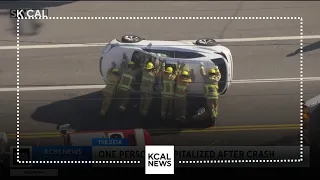 Firefighters flip over car after violent crash in Sherman Oaks