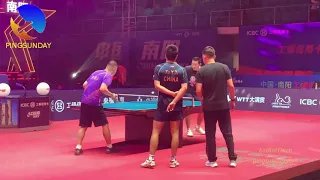 Coach Ma Lin demonstrates to Xu Xin how to receive a serve