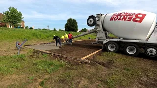 Pouring concrete for a basketball court