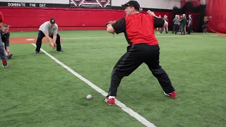 Duke Baxter is demonstrating to youth coaches how to teach fielding a groundball