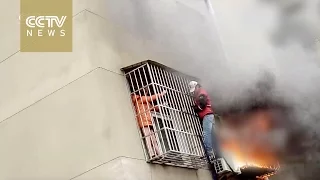 Man climbs three stories to rescue woman trapped by fire