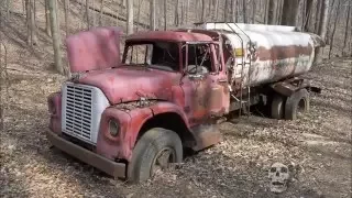 Abandoned trucks in woods in America. Abandoned pickup in USA. Abandoned semi truck