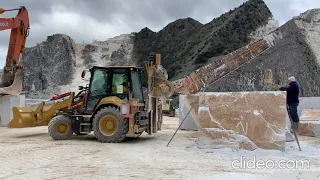 Chain saw QST3000D on backhoe CAT432f2 in various cuts in Carrara quarries