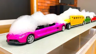 Various Limousine Model Cars Getting Washed In Water