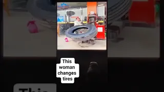 woman changes semi tire