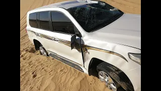 Car accident on sand dunes in the desert with tour operators