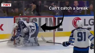 Connor hellebuyck gets hit by his teammate