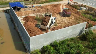 New Project Small Bulldozer Working Pushing Soil Fill Around Fence And Mini Truck Unloading Soil