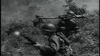 American soldier firing recoilles rifle in Korea during the Korean War;views of North Korean soldier