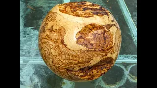 Woodturning a large spalted beech sphere with some copper dust/ glue infills