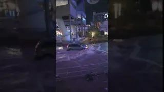 Las Vegas Flooding: Car Drives Through Flooded Roadway On Las Vegas Strip