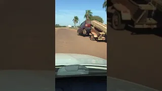 Small car towing a very big and heavy load