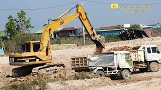 CATERPILLAR REGA 312B Excavator working to dig soils on to Dump Trucks Processing well