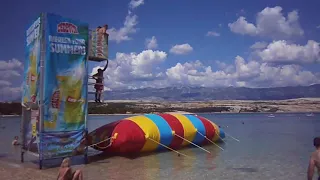 girl goes flying off the inflatable water jumping pillow | CONTENTbible