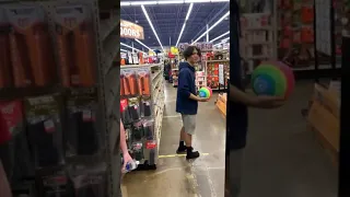 Boy kicks Ball across sports store